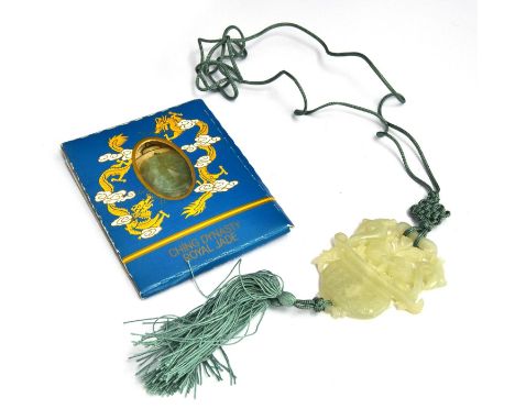A jade pendant on decorative green cord, with another piece marked as being 'Ching Dynasty Royal Jade' 