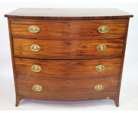 A George III mahogany bow front chest, of four graduated long drawers with oval brass handles embossed with animal heads and 