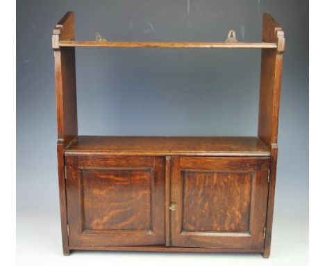 An Edwardian oak hanging shelf, with two cupboard doors, 53cm H x 46cm W