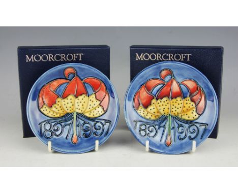 A pair of Moorcroft Centenary pin dishes, plate 1897-1997, each decorated with a lily and dates, impressed and painted marks,