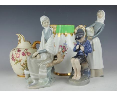 A Copenhagen figure of a seated boy carving, with two Lladro figures, tallest 27cm high, a Royal Worcester flat back jug deco