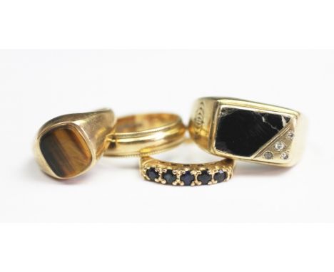 A 9ct yellow gold wedding band, a 9ct gold tigers eye set signet ring and a five stone sapphire ring in 9ct gold, gross weigh