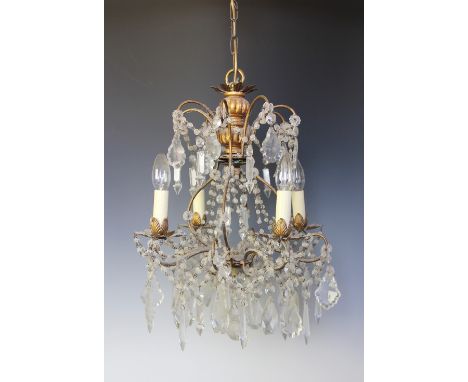 A French gilt metal four light chandelier / ceiling light, hung throughout with cut glass lustre drops and swags, 75cm HLight