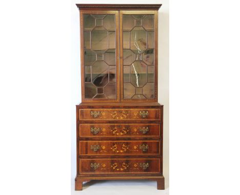 An Edwardian inlaid mahogany bookcase, in the manner of Edwards and Roberts of slender proportions, with dentil cornice above
