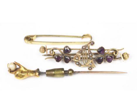 An amethyst set 'Irish' brooch, designed as a central seed pearl set lyre flanked by two amethyst set shamrocks, all set in 1