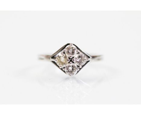A four stone diamond ring, the four brilliant cut diamonds within unusual kite shaped setting, all claw set in white metal to