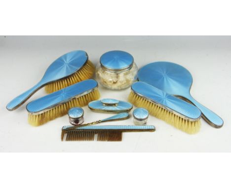 A blue enamelled silver dressing table set, Albert Carter, Birmingham 1932, each silver piece with blue guilloche enamel back