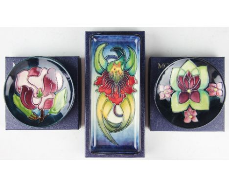 A Moorcroft Anna pattern tray, 20cm long, along with two pin dishes comprising; Magnolia 1993 and Violet 1993, each 11.8cm di