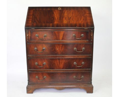 A 1920's mahogany bureau, the fall enclosing a compartmented interior with leather insert, on bracket feet, 99cm H x 73.5cm W