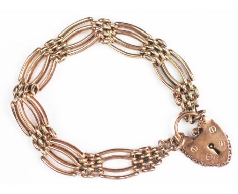 A 9ct yellow gold gate type bracelet with padlock clasp and attached safety chain, gross weight 22.7gms