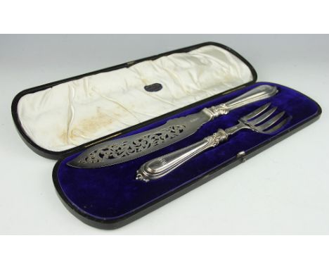 A cased pair of Victorian silver fish servers, John Gammage, Birmingham 1855, each handle florally cast and monogrammed, knif