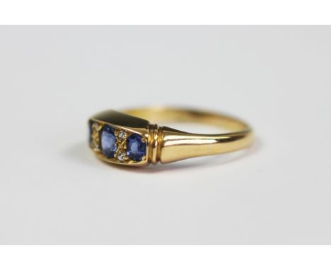 An Edwardian sapphire and diamond ring, Birmingham 1910, the three sapphires interspersed with four diamonds, all set in 18ct