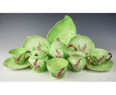 A Carlton Ware Foxglove pattern tea for two service, comprising a teapot and cover, sugar bowl and cover, sugar bowl, milk ju