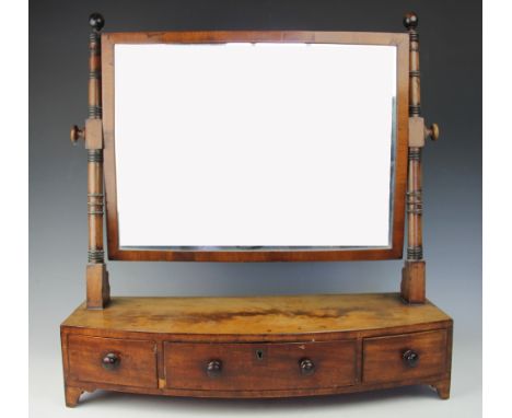 A Regency mahogany bow front toilet mirror, with three drawers, on bracket feet, 62cm H x 57cm W