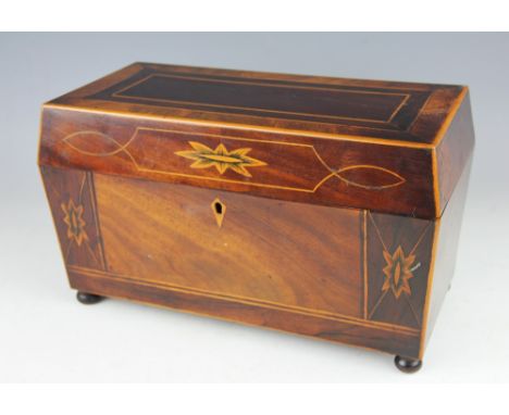 A George III mahogany and rosewood inlaid tea caddy, the sarcophagus shaped caddy inlaid floral motifs, with three internal c
