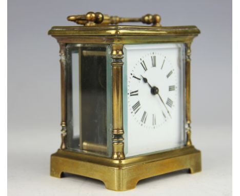 A late 19th century French brass carriage time piece, with enamel Roman numeral dial (at fault), 10cm, with a Mauclineware ro