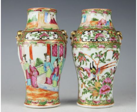 A pair of 19th century Chinese Canton famille rose enamelled vases of small baluster form, each decorated with two panels of 