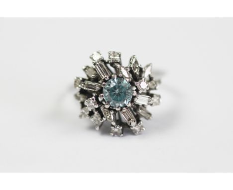 A blue zircon and diamond dress ring, designed as a central circular zircon within a surround of baguette and brilliant cut d