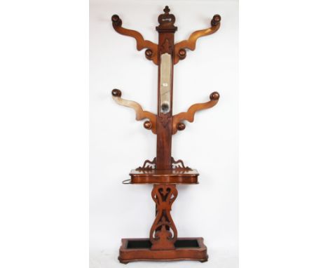 A Victorian mahogany hall stand, the mirror inset back with eight hooks, above a box and umbrella / stick stand, on serpentin