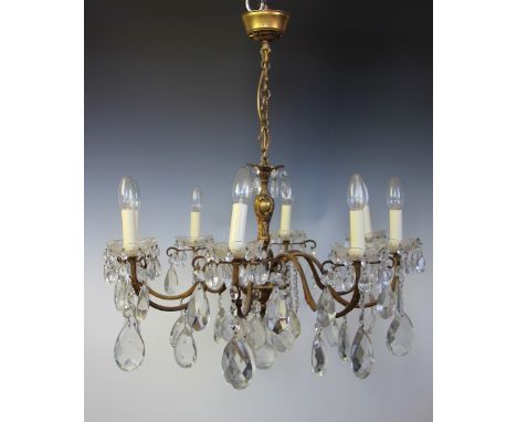 A French gilt brass and cut glass eight light ceiling light, with reeded scroll arms and lustre drops, 68cm diameterLighting 