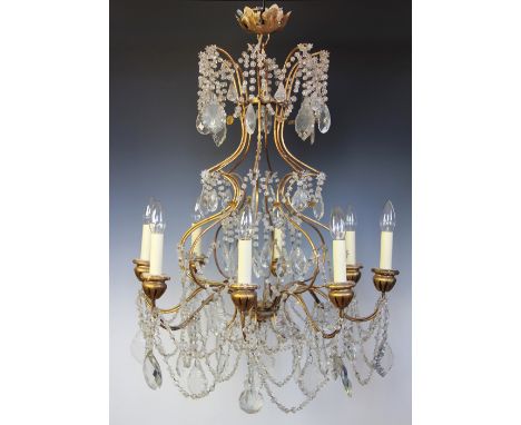 A French gilt metal eight light chandelier / ceiling light, hung throughout with cut glass lustre drops, swags and ball centr