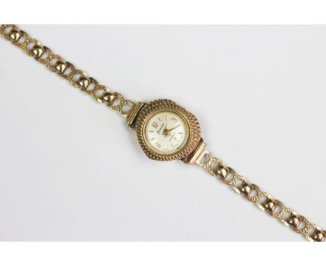 A 9ct yellow gold Accurist ladies wristwatch, the heart shaped face with engine turned detail and champagne dial with batons,