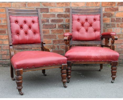 A pair of late Victorian walnut and red leather library chairs, with button backs, on turned legs (2)