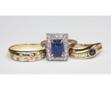 A 9ct yellow gold band inset with seven cz colourless stones, along with a 9ct yellow gold blue and colourless cz set ring an