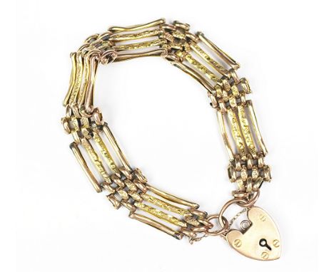 A yellow metal gate type bracelet with attached padlock clasp, with textured finish to the links, clasp stamped 'J.B.R 9c', w