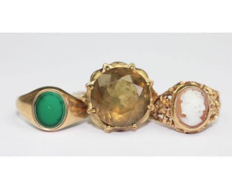 A green stone set 9ct gold signet ring, a carved shell cameo set ring in 9ct yellow gold and a smokey quartz set 9ct yellow g