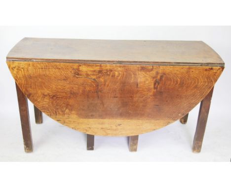 An 18th century provincial oak gate leg table, with circular top, on chamfered square legs, 71cm H x 137cm W x 153cm D