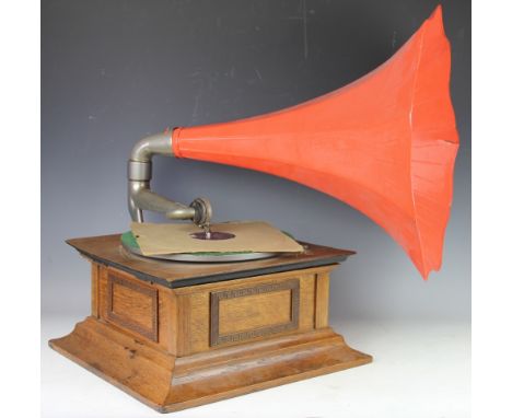 An early 20th century gramophone, with oak case with brass greek key decoration, record and painted speaker horn 