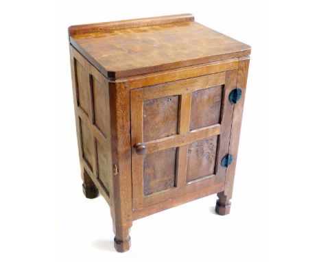 Robert (Mouseman) Thompson oak bedside locker, rectangular adzed top above single four panel door with wasted octagonal legs,