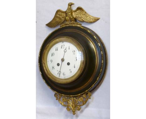 French patinated and gilt brass wall clock, the circular case with a cast egg and dart bezel, eagle crest and leaf scroll tai