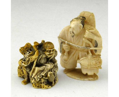 Japanese ivory netsuke of a merchant weighing cabbage, signed, height 55mm (damage); also a composition netsuke of a sea imp 