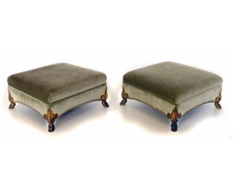 A pair of early 19th century regency style footstools, each with upholstered square frame and standing on cast ormolu bracket