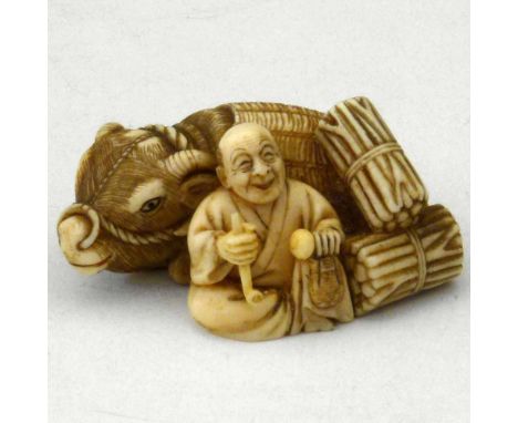 Japanese ivory netsuke of a man beside a water buffalo with bales of kindling, signed, Taisho period, length 47mmCondition re