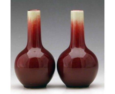 Pair of Chinese sang de boeuf small bottle vases, four character seal mark to base, 20th century, height 12.5cm. Condition re