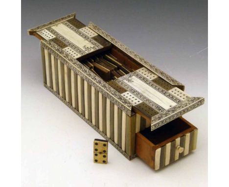 Indian ivory, bone and horn sandalwood games box with a cribbage board sliding top and lower drawer, containing a set of bone