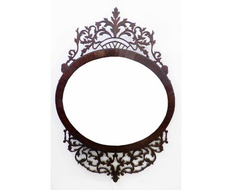 Mahogany pierced wall mirror, the oval portrait oriented glass surrounded by a band of purfling and an elaborately pierced an