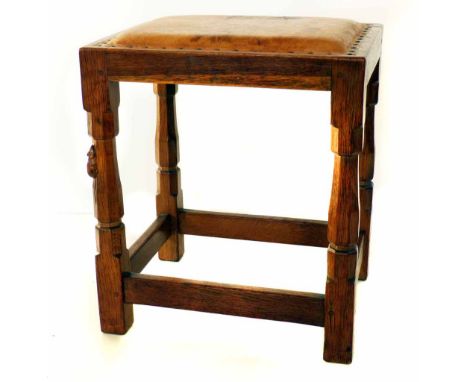 Robert (Mouseman) Thompson stool, oak frame, close nailed leather covered upholstered seat, four baluster section legs united