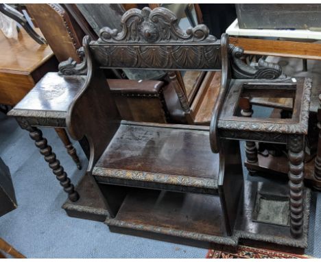 A late Victorian oak hall bench, heavily carved with bobbin turned supports and stick stand with a drip tray, 100.5h x 118.5w