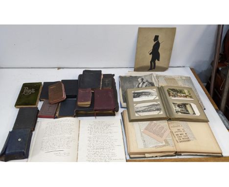 A collection of vintage books and albums to include a collection of bibles and prayer books, an album of six vintage postcard