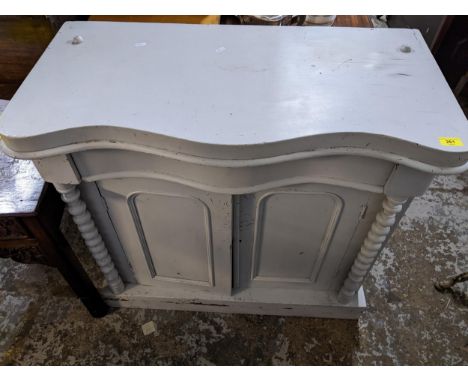 A painted Victorian chiffoniere base, serpentine fronted, single drawer above twin arched cupboard doors, flanked by open bob