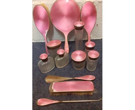 An Edwardian 13 piece silver, white metal and pink enamelled dressing table set to include 3 brushes and 7 glass bottles. Loc