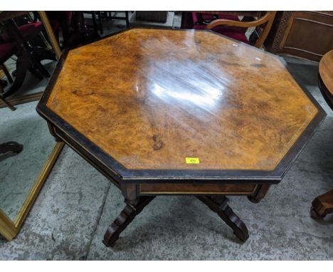 A Victorian ascetics style table, quarter cut walnut octagonal top with engraved and ebonized borders, recessed panel frieze 