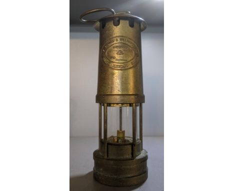 E Thomas and Williams Ltd Cambrian miners lamp no 304425, 25cm h and a leather bound caseLocation:If there is no condition re