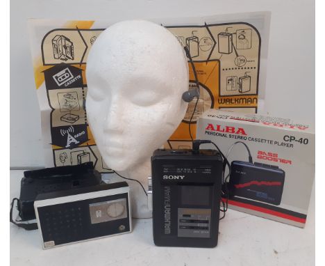 A Retro Sony Walkman Mega Bass FM/AM radio cassette portable player with headphones together with an Alba CP-40 personal ster