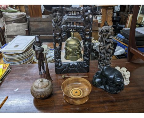 A mixed lot of ethnographical and other items to include a Canadian Inuit sculpture of an Eskimo and a seal, Chinese brass te