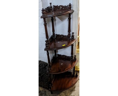 A reproduction mahogany four shelf corner what not, with turned finials and carved and pierced scroll leaf decorationLocation